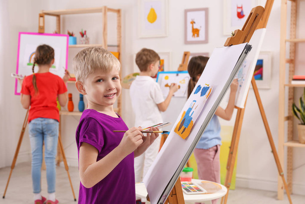 Cute little children painting during lesson in room - Φωτογραφία, εικόνα