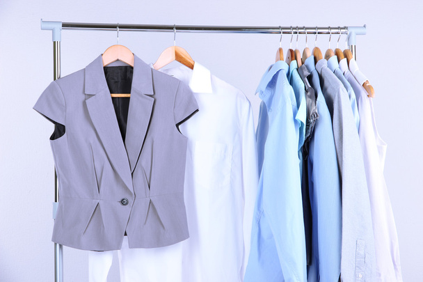 Office clothes on hangers, on gray background - Fotó, kép