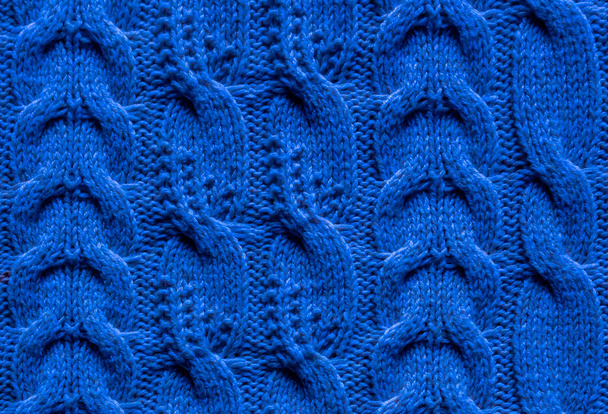 Knitted fabric with a pattern of braids of different types. - Photo, Image