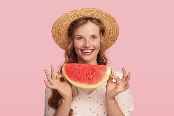 Excited young woman with piece of watermelon - Zdjęcie, obraz