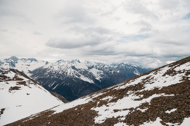 Θέα ψηλά χιονισμένες βουνοκορφές καλύπτονται με αφράτο - Φωτογραφία, εικόνα