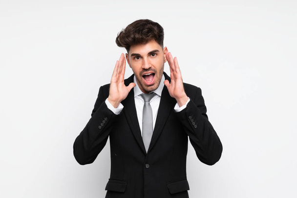 Young businessman over isolated white background shouting with mouth wide open - Фото, изображение
