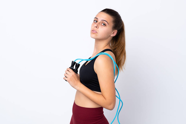 Teenager sport girl over isolated white background with jumping rope - Фото, зображення