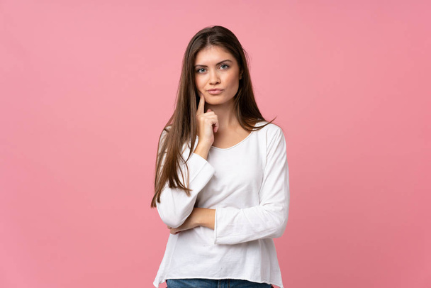 Young woman over isolated pink background Looking front - Fotografie, Obrázek