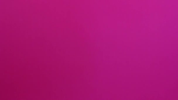 Women hands and arms exchanging thank you card with saturated pink background - Filmagem, Vídeo