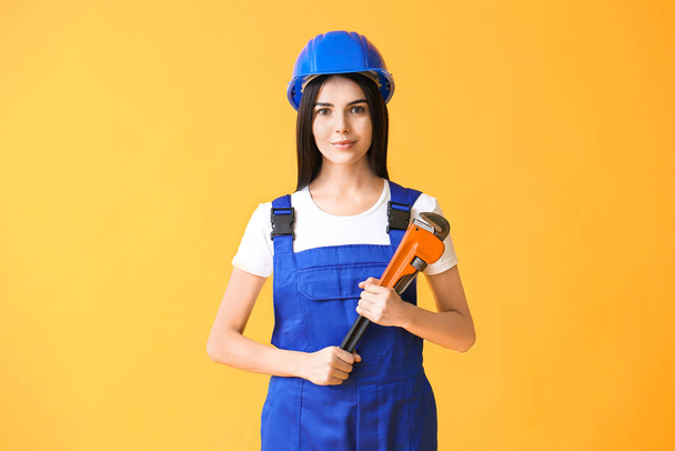 Female worker against color background. Concept of feminism - Foto, afbeelding