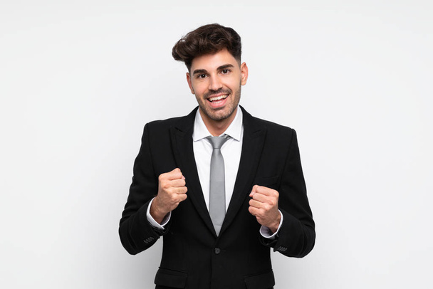 Young businessman over isolated white background celebrating a victory - Photo, Image
