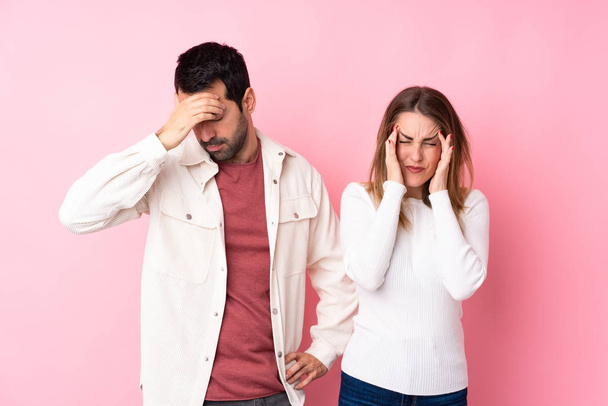 Couple in Valentine Day over isolated pink background unhappy and frustrated with something - Foto, immagini