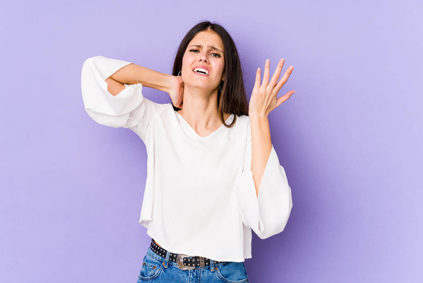 Young caucasian woman isolated on purple background screaming with rage. - Photo, Image