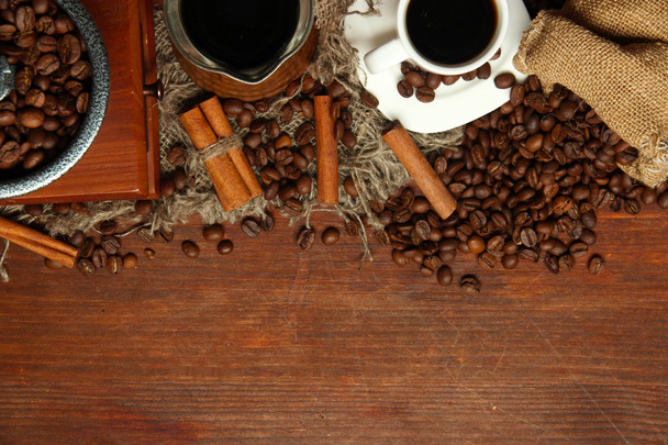 Coffee beans, metal turk and coffee mill on wooden background with copy space - Photo, Image