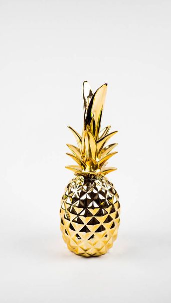 golden pineapple on a white background. copy space - Fotografie, Obrázek