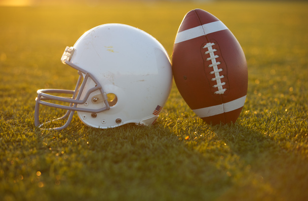 Football and Helmet on the Field - Photo, Image