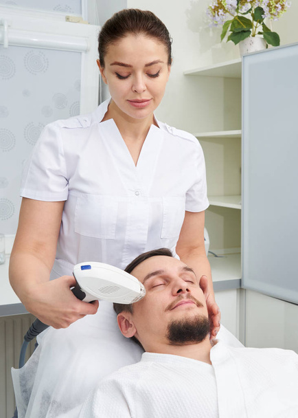 Man Having Laser Treatment At Beauty Clinic - Valokuva, kuva