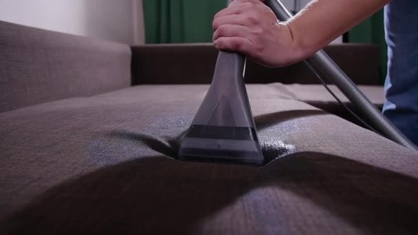 Cleanliness concept. Dry cleaning worker removing dirt from upholstered furniture - Footage, Video