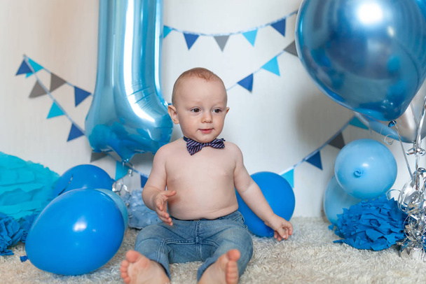 Baby's birthday in the decorated area, portrait of a happy boy - Foto, imagen