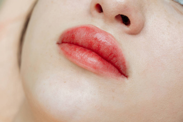 Lips after permanent makeup in beauty salon - Valokuva, kuva