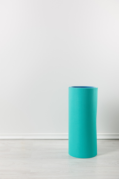 one blue fitness mat on floor at home - Photo, Image