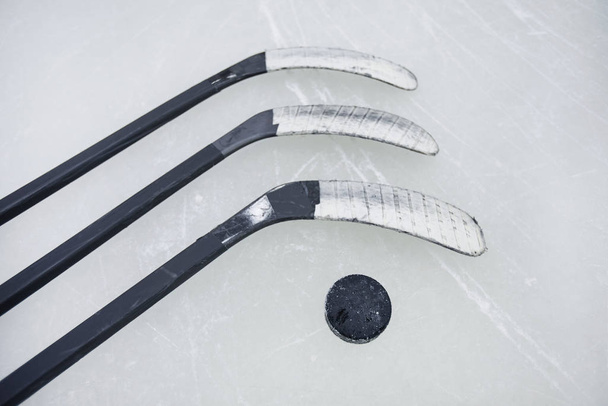 Top view background of hockey sticks and pluck laid out on ice, copy space - Photo, Image