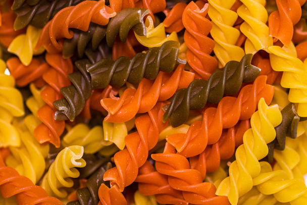 Composition of raw pasta uncooked tricolore fusilli, pasta twist - Photo, Image