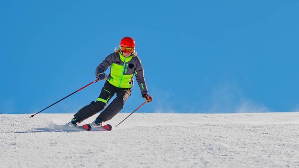 A ski instructor while skiing alone in a ski resort - Foto, Imagen