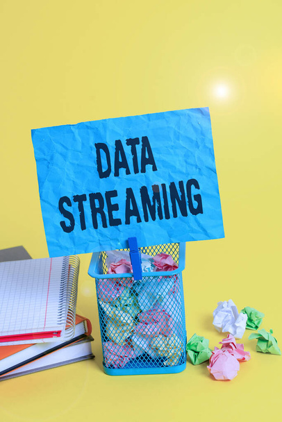 Text sign showing Data Streaming. Conceptual photo data that is continuously generated by different sources Trash bin crumpled paper clothespin empty reminder office supplies yellow. - Photo, Image