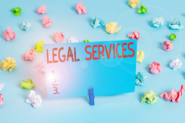 Writing note showing Legal Services. Business photo showcasing any services involving legal or law related matters Colored crumpled papers empty reminder blue floor background clothespin. - Photo, Image
