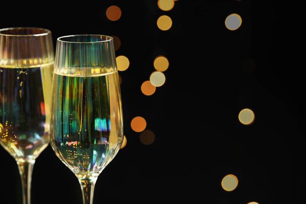 Glasses of champagne against blurred lights, closeup. Space for  - Foto, Imagem