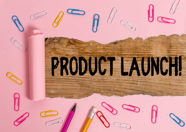 Text sign showing Product Launch. Conceptual photo process to introduce new product for sale for the first time Stationary and torn cardboard placed above a wooden classic table backdrop. - 写真・画像