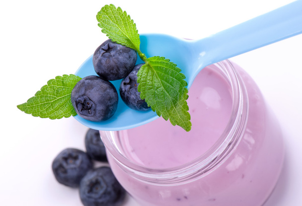 Blueberry and fruits yogurt close up, on white. - Foto, imagen
