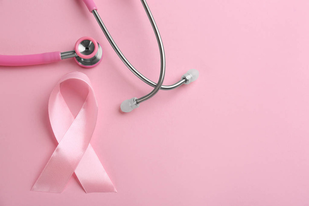 Pink ribbon and stethoscope on color background, flat lay with s - Φωτογραφία, εικόνα
