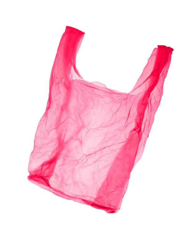 Beyaz arka planda kırmızı-pembe plastik torba. Izole - Fotoğraf, Görsel