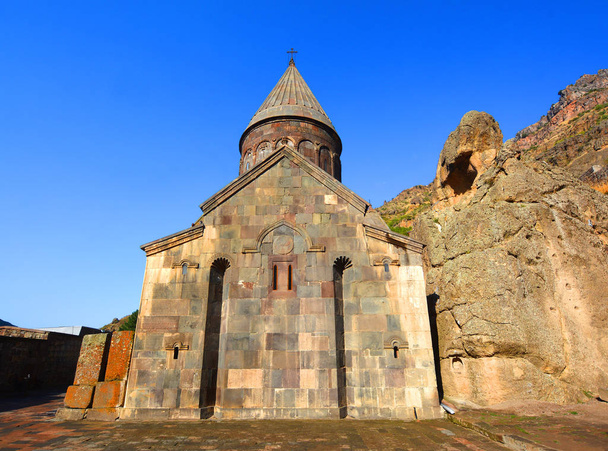 KOTAYK ARMENIA 09 15 19: Geghard is a medieval monastery in the Kotayk province of Armenia, carved out of the adjacent mountain. It is listed as a UNESCO World Heritage Site. - Foto, afbeelding