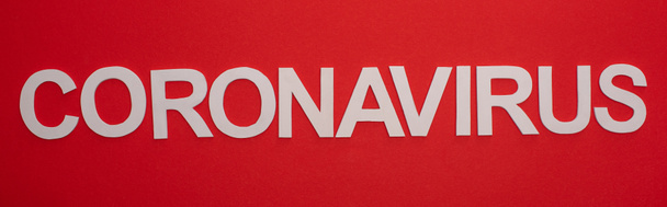 Top view of coronavirus lettering isolated on red, panoramic shot - Valokuva, kuva