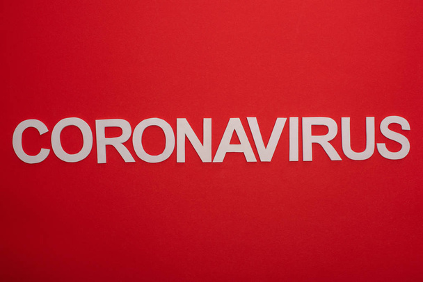 Top view of coronavirus inscription isolated on red - Zdjęcie, obraz