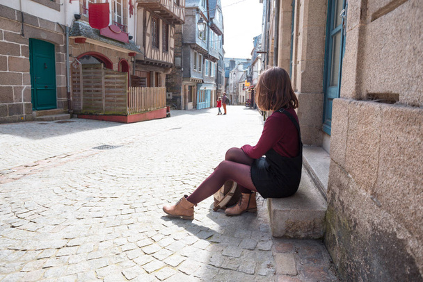 girl is walking in the old town Morlaix  - Фото, изображение