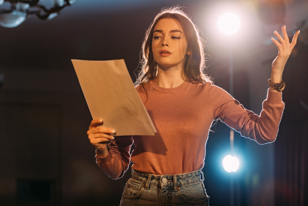 young actress reading scenario on stage in theatre - Foto, Bild