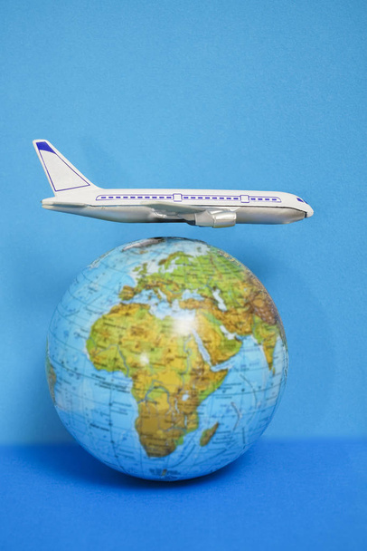 Plastic toy plane on the globe. Flight travel concept. Travel by airplane. Takeoff and landing of the aircraft. Return home from flight. empty Copy space.  - Photo, Image