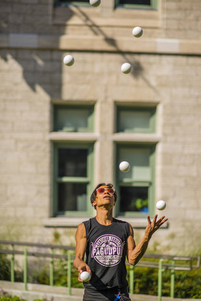 Quebec City, Canada - August 21, 2019: The Ball juggler playing ball in downtown Quebec City - Φωτογραφία, εικόνα