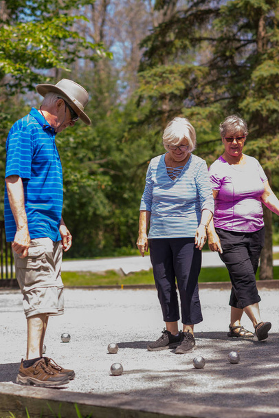 Saint Hubert, Canada - July 28, 2019: The elders playing the petanque game in the Parc de la Cit in Saint Hubert - 写真・画像