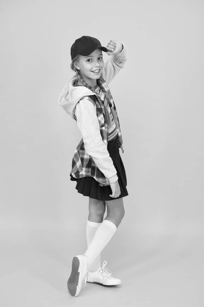 Cool schoolgirl. Have fun charismatic girl on yellow background. Tomboy concept. Teen age. Girl adorable stylish outfit teenager. Comfortable outfit. Modern outfit. Rebellious teen. Street style - Φωτογραφία, εικόνα