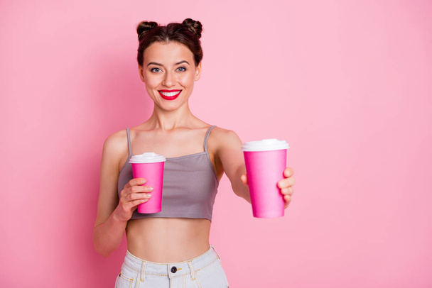 Portrait of charming lovely girl hold coffee order give tea cappuccino mug to her friend enjoy summer free time wear casual style clothing isolated over pink color background - Valokuva, kuva