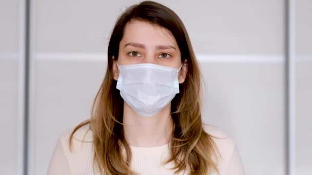 Close-up of a young woman in a protective medical mask - Video