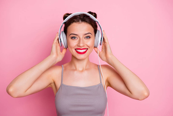 Portrait of charming lovely gilr listen music with her white ear phones feel content wear casual style clothing isolated over pink color background - Foto, imagen