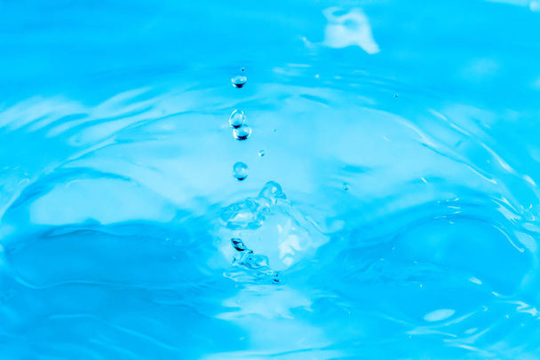 Ripples of beautiful water drops falling on water - Photo, Image