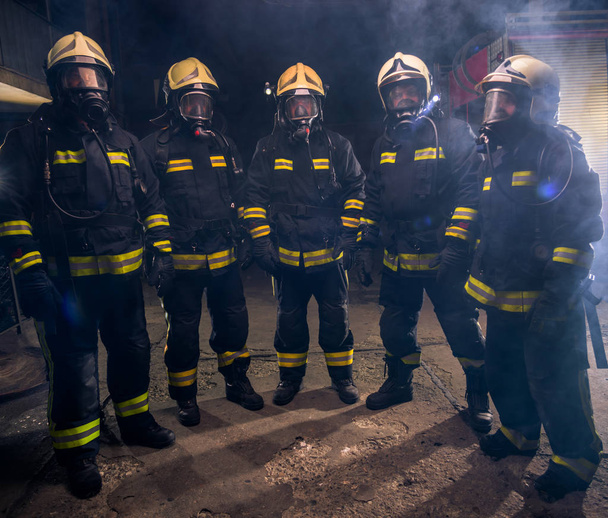 Portrait of group of firefighters in the middle of the smoke of  - Photo, Image