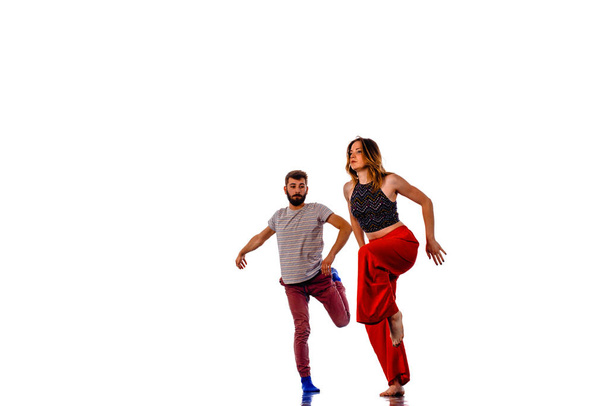 Young modern dancers dancing in the studio. Sport, dancing and urban culture concept - Foto, Imagen