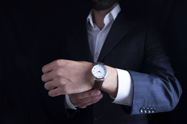 Businessman checking time from watch - Photo, image