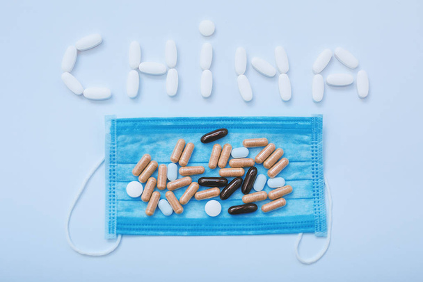 Medical mask and pills. The virus problem in China - 写真・画像