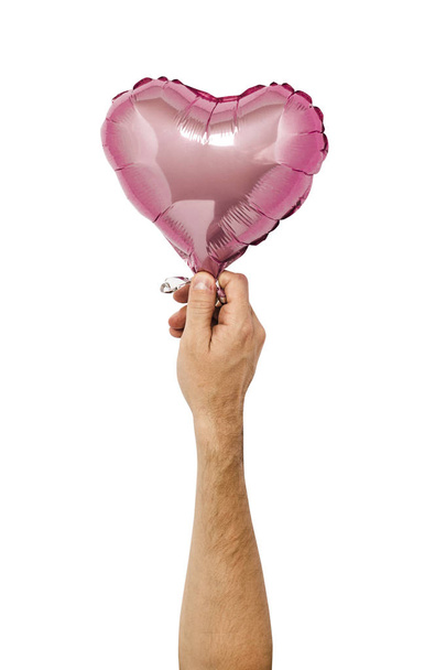 Globo de aire rosa sostenido por una mano sobre un fondo aislado. Boda conceptual, día de San Valentín, zona de fotos, amantes. Banner Plano laico, vista superior
 - Foto, Imagen