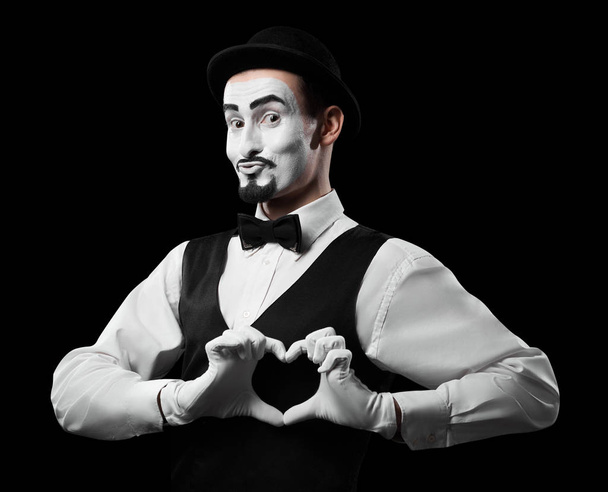 Mime artist showing love sign with hands. Isolated on black. Valentines day concept. - Photo, Image